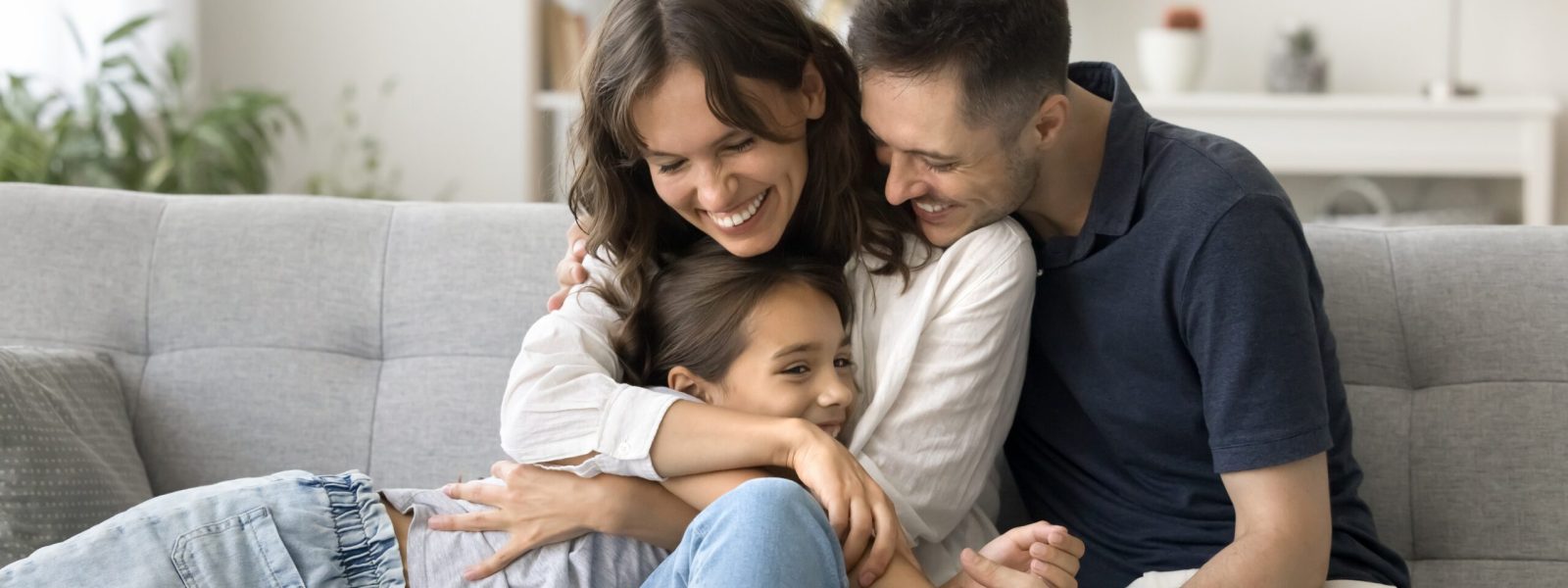 Happy,Young,Parents,Cuddling,Sweet,Adorable,Kid,Girl,On,Comfortable